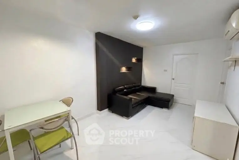 Modern living room with sleek black sofa and minimalist decor