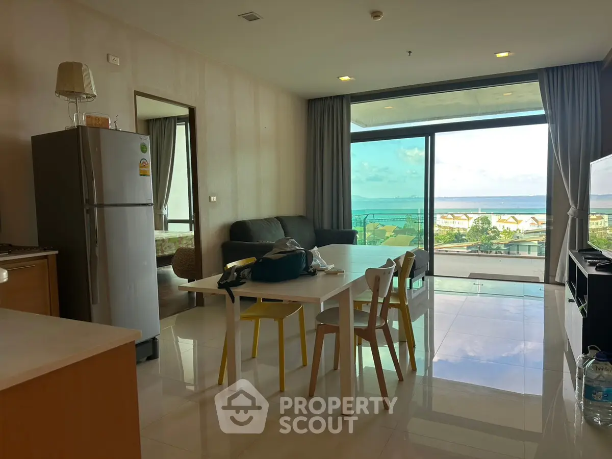 Modern living room with ocean view, open layout, and stylish furniture.