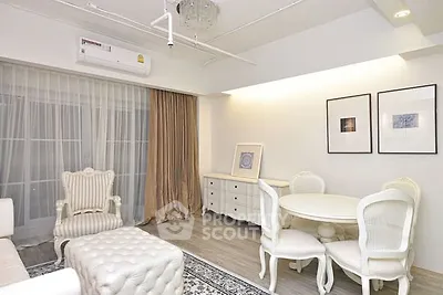 Elegant living room with classic white furniture and stylish decor