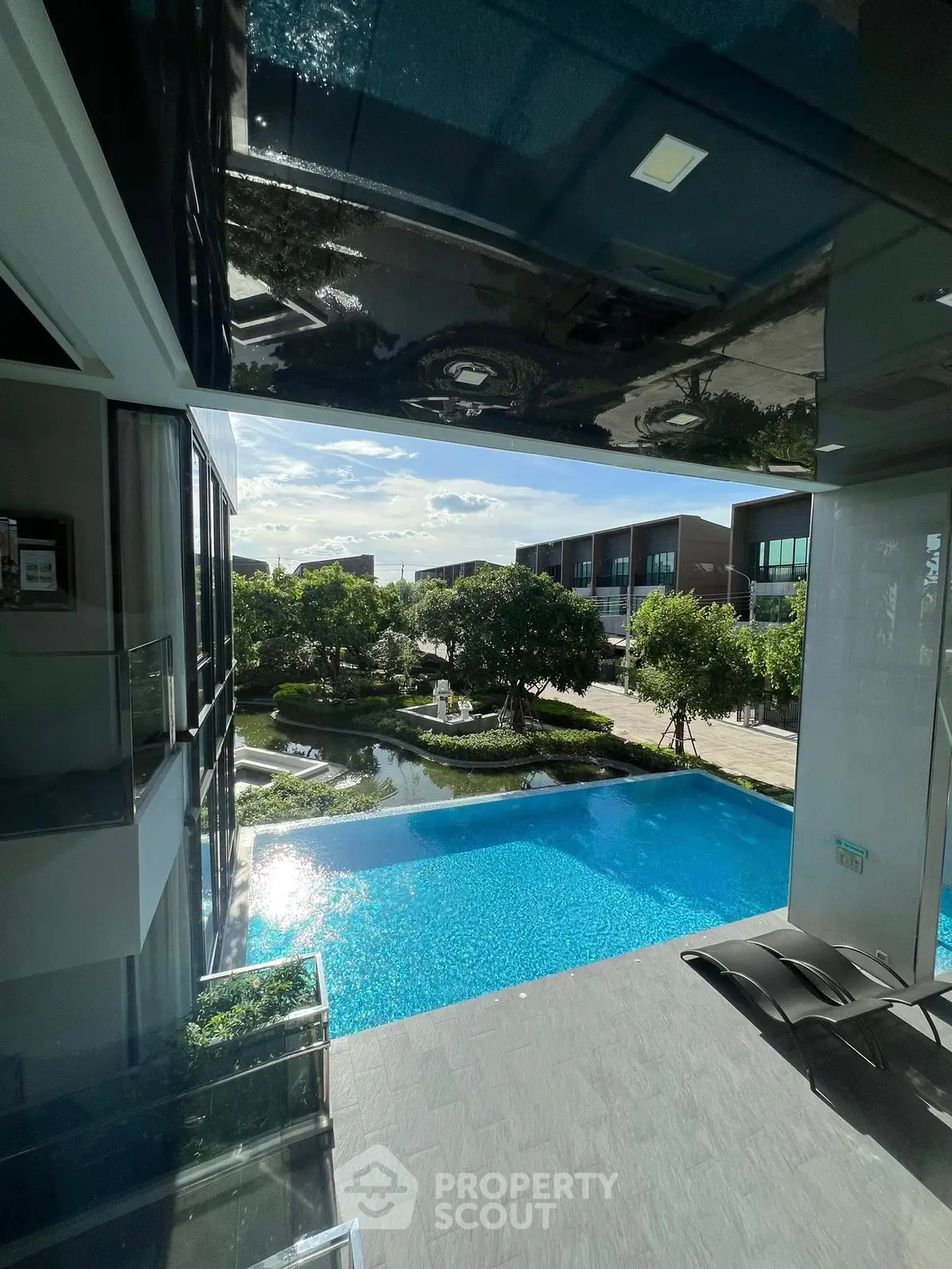 Luxurious modern building with stunning pool and garden view