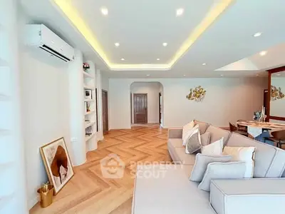 Spacious living room with modern decor and elegant lighting