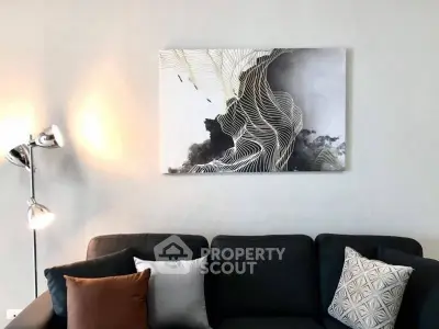 Modern living room with stylish sofa and abstract wall art, perfect for contemporary home decor.