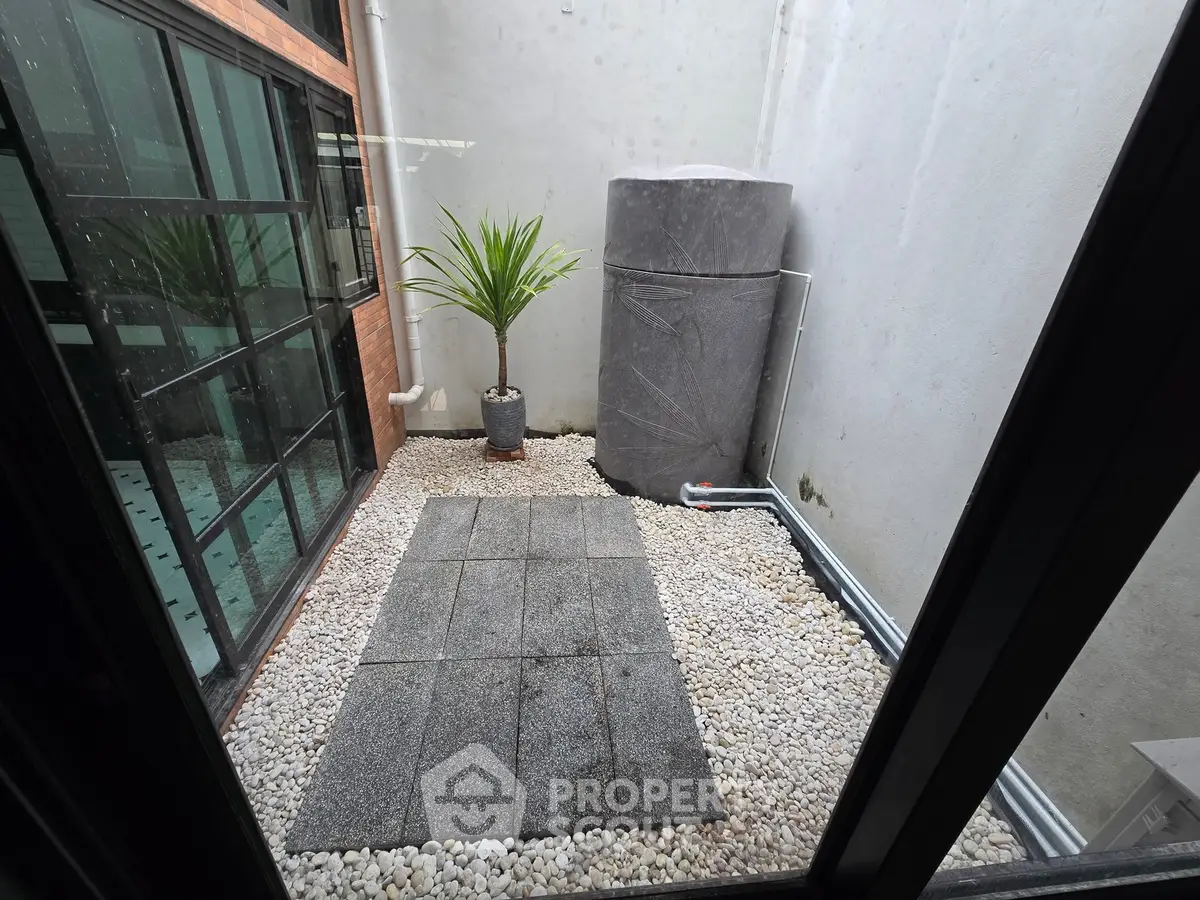 Chic urban courtyard with modern design and sleek stone features, perfect for stylish outdoor living.