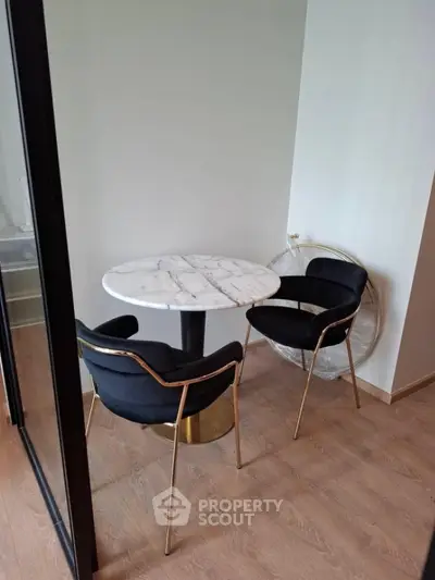 Cozy dining nook with marble table and elegant chairs in modern apartment