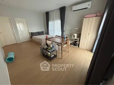 Spacious bedroom with modern furniture and natural light