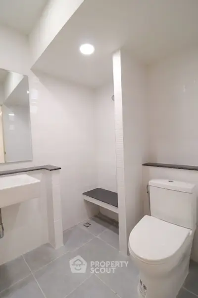 Modern minimalist bathroom with sleek fixtures and neutral tones