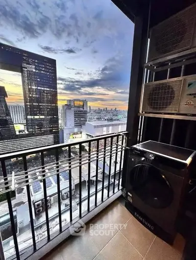 Stunning city view from high-rise balcony with modern appliances, perfect for urban living.