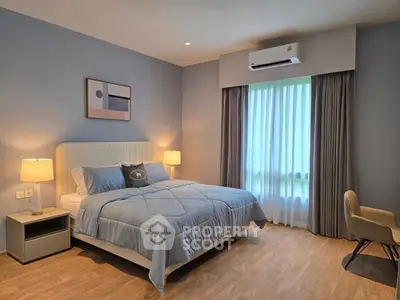 Modern bedroom with stylish decor and natural light, featuring a comfortable bed and elegant furnishings.