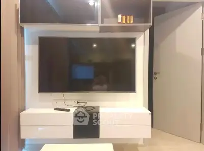 Modern living room with sleek TV unit and open door design