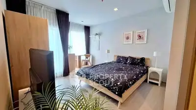 Spacious modern bedroom with stylish decor and natural light