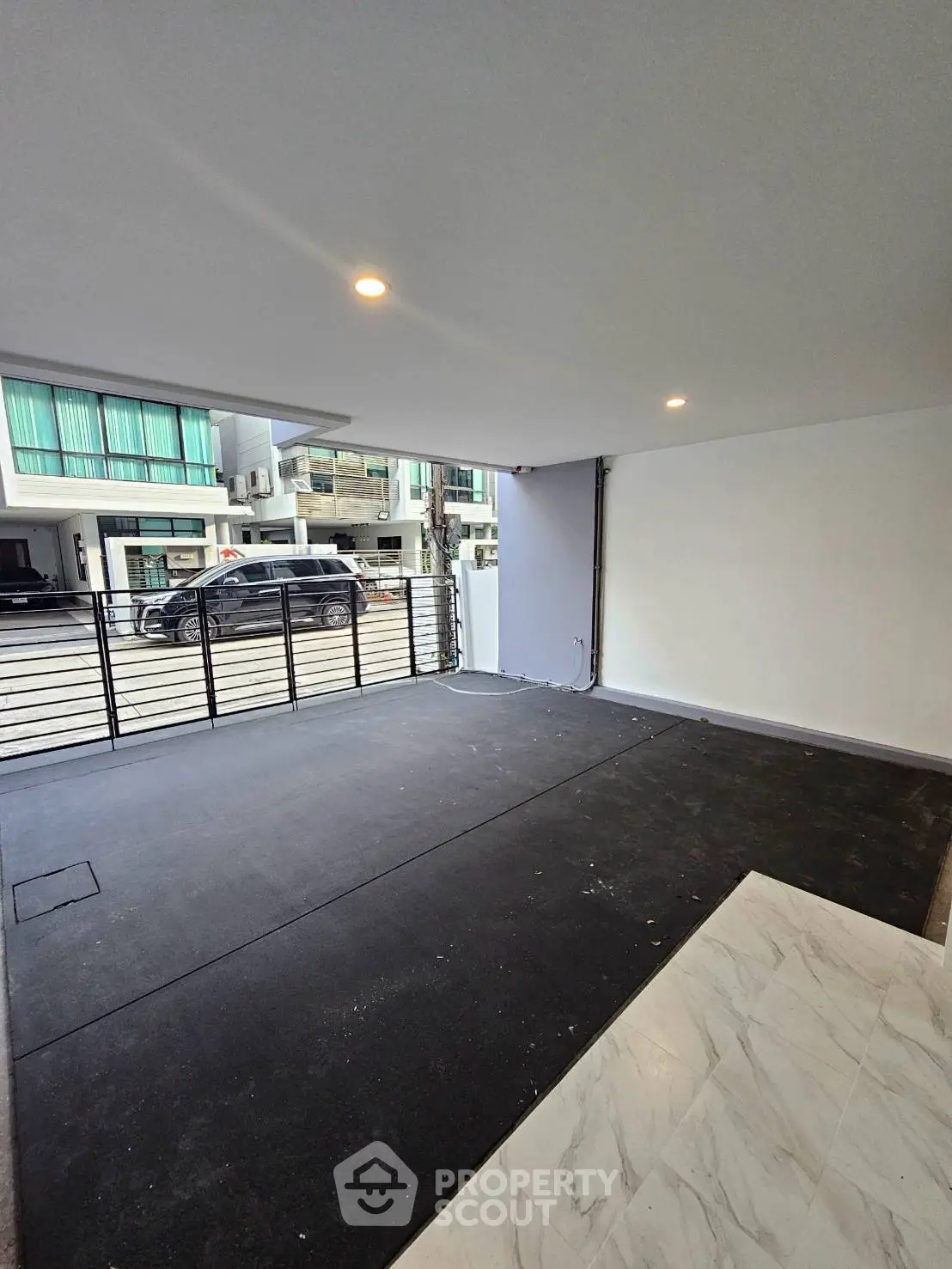 Spacious modern garage with sleek design and ample lighting, perfect for urban living.