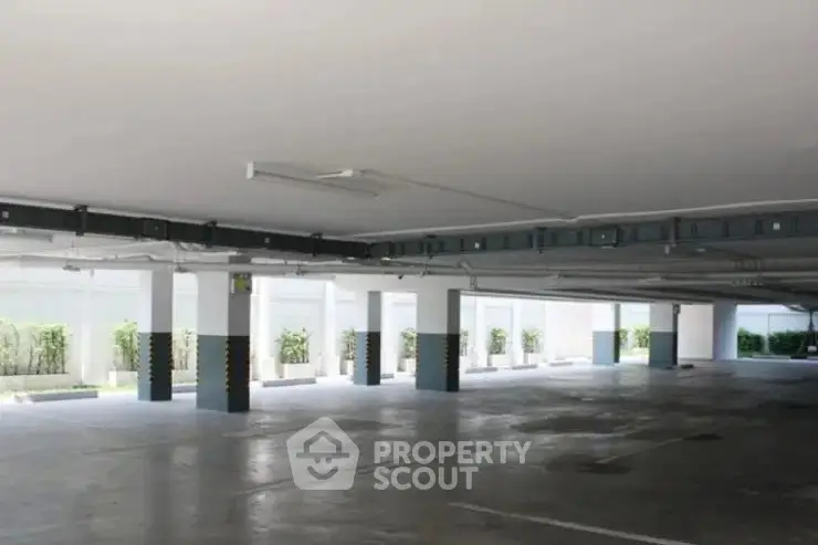 Spacious covered parking area in modern residential building