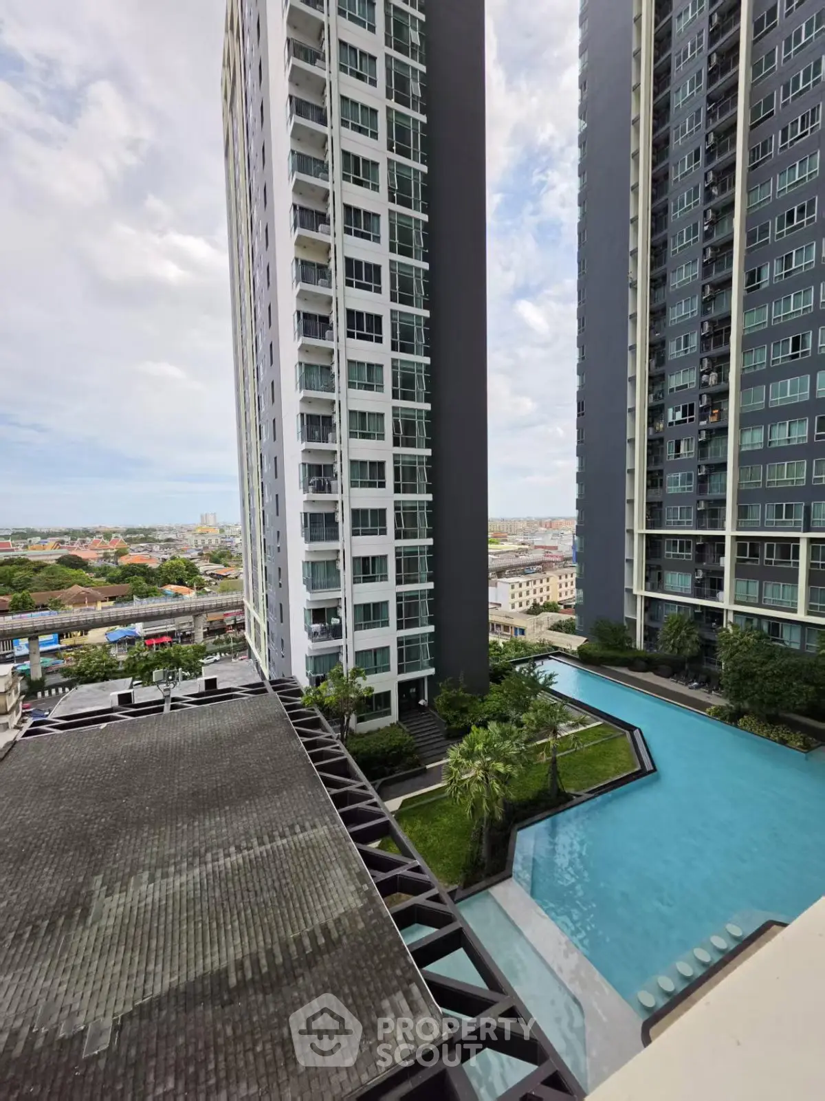 Stunning high-rise apartment complex with modern pool and city view
