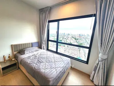 Modern bedroom with stunning city view from large window, featuring cozy bed and elegant curtains.