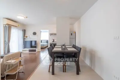 Spacious open-plan living and dining area with modern furnishings and natural light.