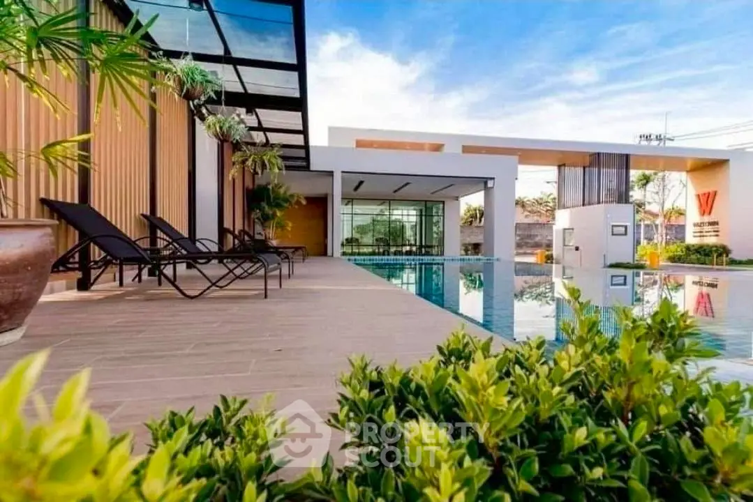 Luxurious poolside view with modern architecture and lush greenery, perfect for relaxation and leisure.