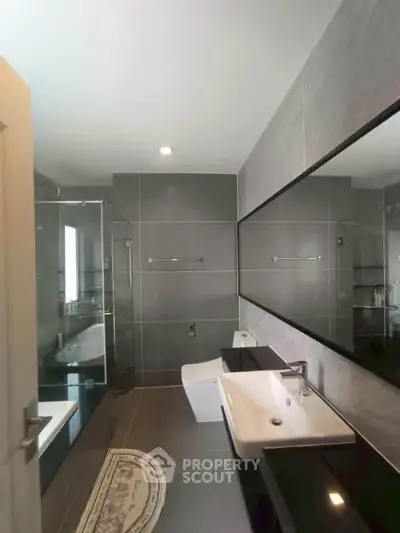 Luxurious modern bathroom with sleek fixtures and spacious design.