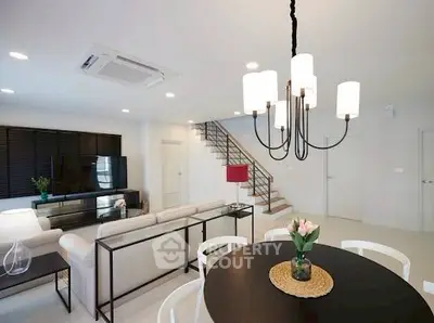 Modern open-plan living room with stylish decor and elegant lighting