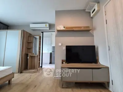 Modern living room with sleek furniture and air conditioning in a stylish apartment.