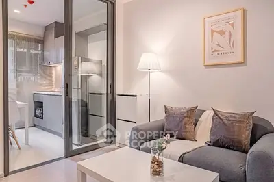 Modern living room with cozy sofa and stylish kitchen view