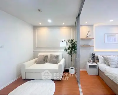 Modern studio apartment with cozy living area and stylish bedroom, featuring elegant decor and warm lighting.
