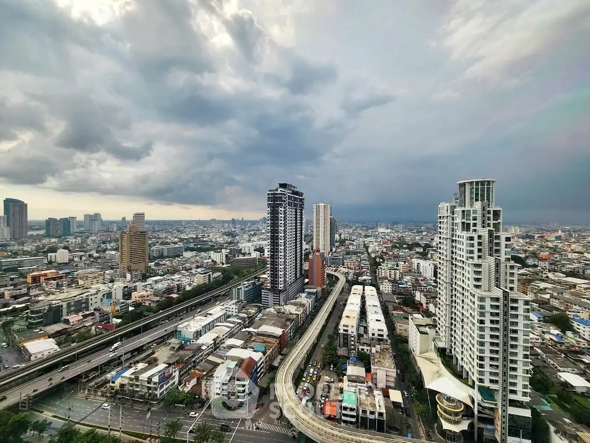 Stunning cityscape view showcasing modern high-rise buildings under dramatic cloudy skies.