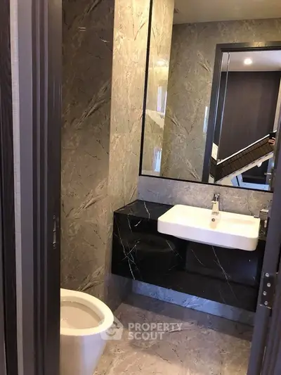 Luxurious modern bathroom with marble walls and sleek fixtures