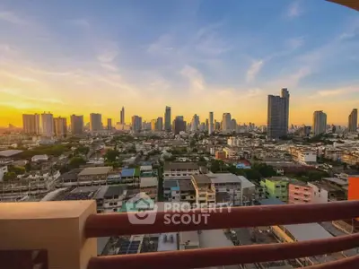 Stunning cityscape view from a high-rise balcony at sunset, showcasing urban skyline and vibrant colors.