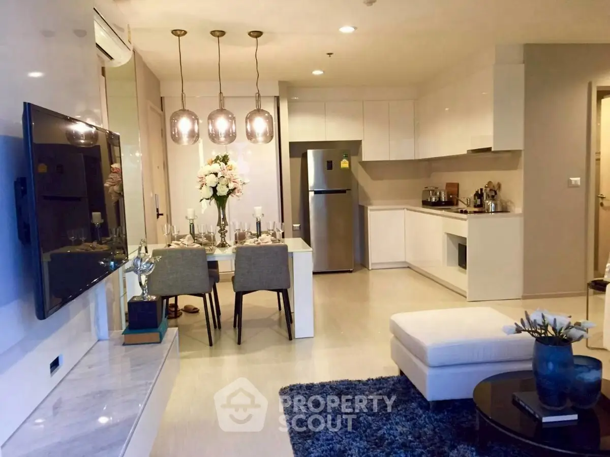 Modern open-plan living room and kitchen with stylish decor and dining area.