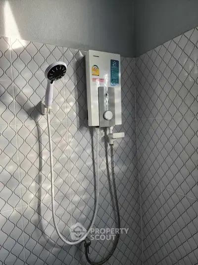 Modern bathroom shower with sleek white tiles and water heater