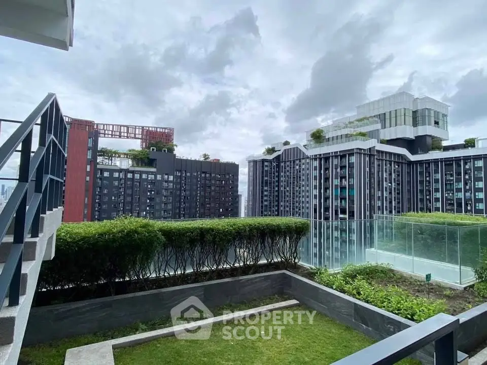 Modern urban apartment buildings with lush rooftop gardens and glass balconies.