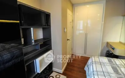 Cozy bedroom with modern storage solutions and sleek design.