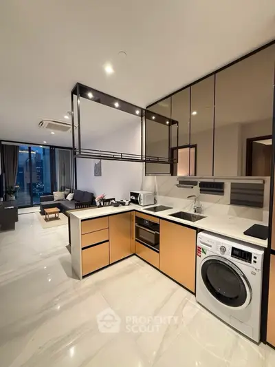 Modern open-layout kitchen with sleek appliances and spacious living area in luxury apartment.
