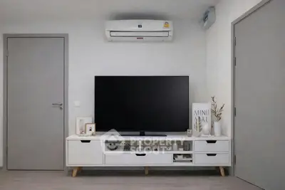 Modern minimalist living room with sleek TV unit and air conditioning