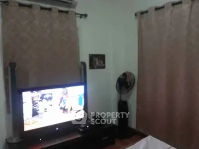 Cozy living room with TV and elegant curtains