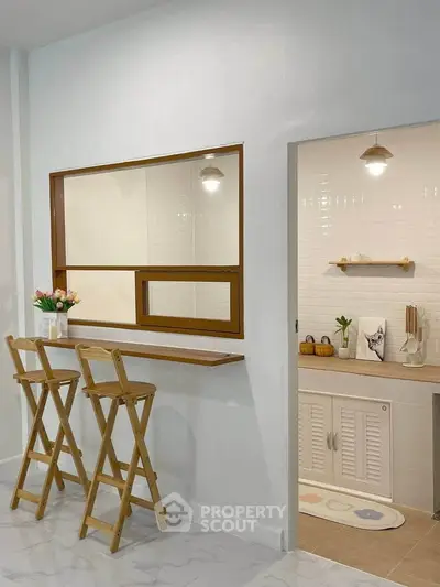 Charming kitchen with breakfast bar and modern lighting, perfect for cozy meals and gatherings.