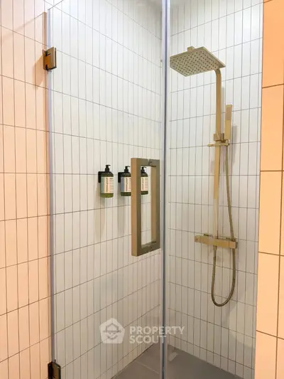 Modern bathroom shower with sleek glass door and rainfall showerhead in contemporary design.