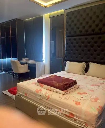 Luxurious bedroom with plush headboard and stylish decor, perfect for relaxation and comfort.
