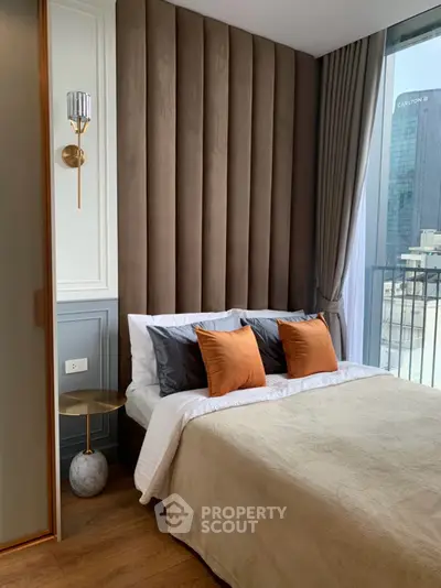 Luxurious bedroom with modern decor and city view, featuring plush bedding and elegant lighting.