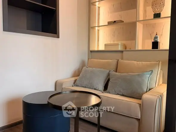 Cozy living room with modern sofa and stylish shelving unit, perfect for relaxation and decor display.