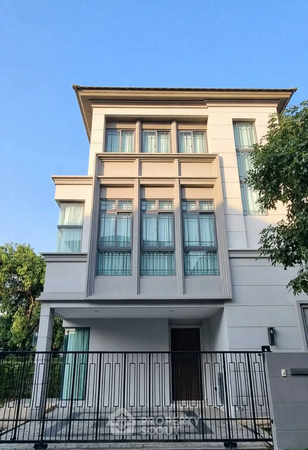 Modern three-story house with elegant facade and large windows