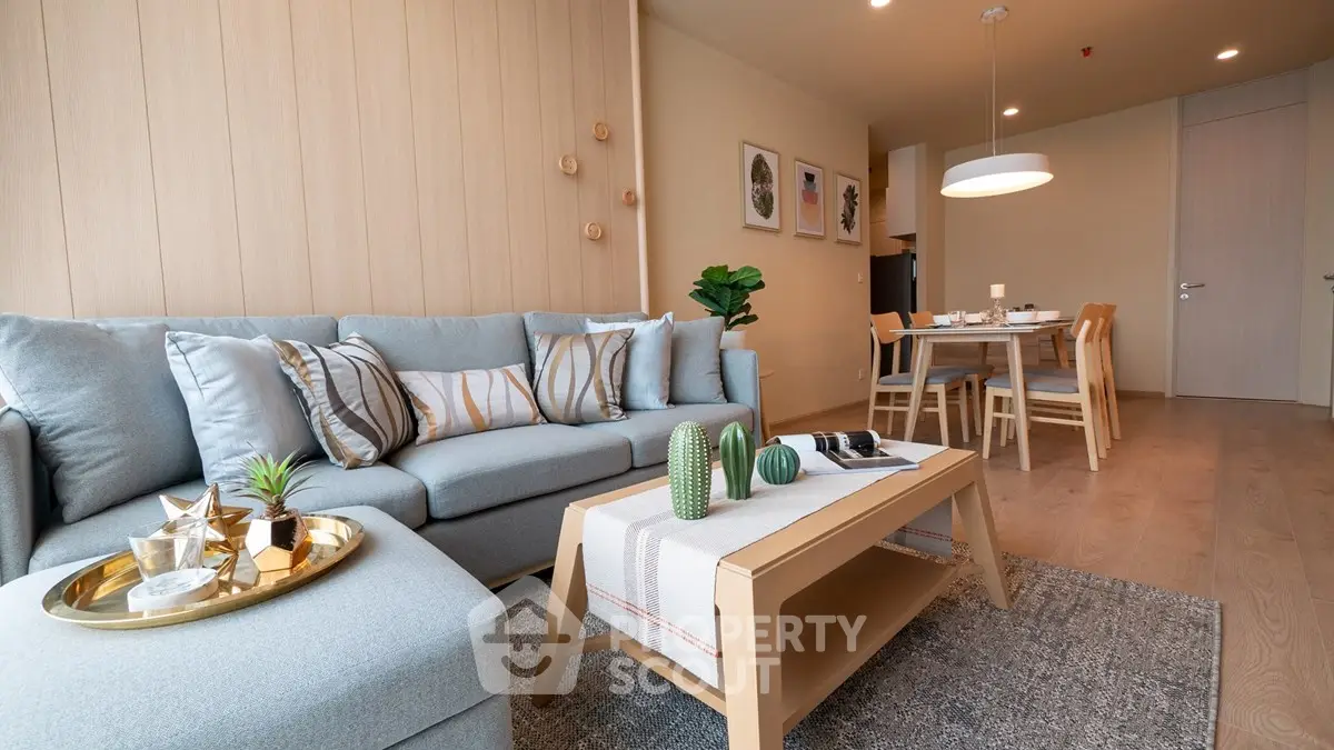 Modern living room with stylish decor and dining area in open layout apartment.