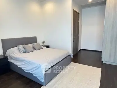 Modern bedroom with stylish decor and cozy ambiance, featuring a comfortable bed and sleek furnishings.
