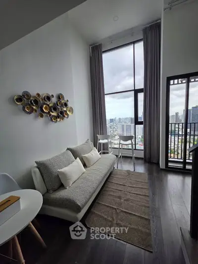 Modern living room with high ceiling and city view from large windows