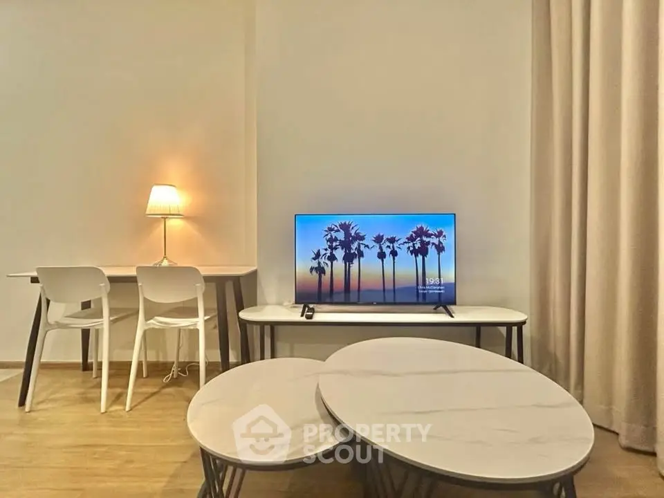 Modern living room with stylish furniture and ambient lighting, featuring a sleek TV setup and elegant decor.