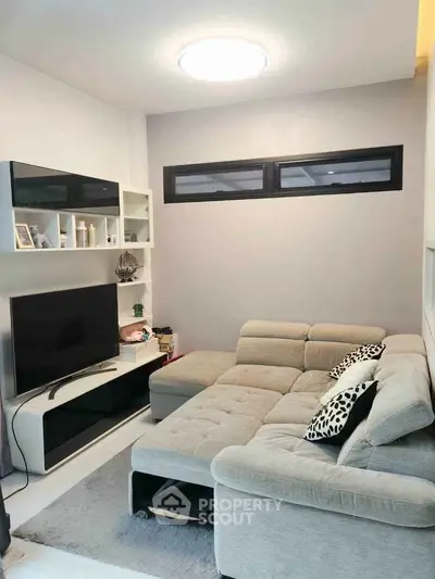 Modern living room with stylish sectional sofa and entertainment center