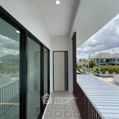Modern balcony with sleek railing and scenic neighborhood view