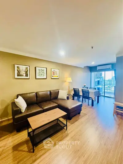 Spacious living room with modern decor and balcony access in a stylish apartment.