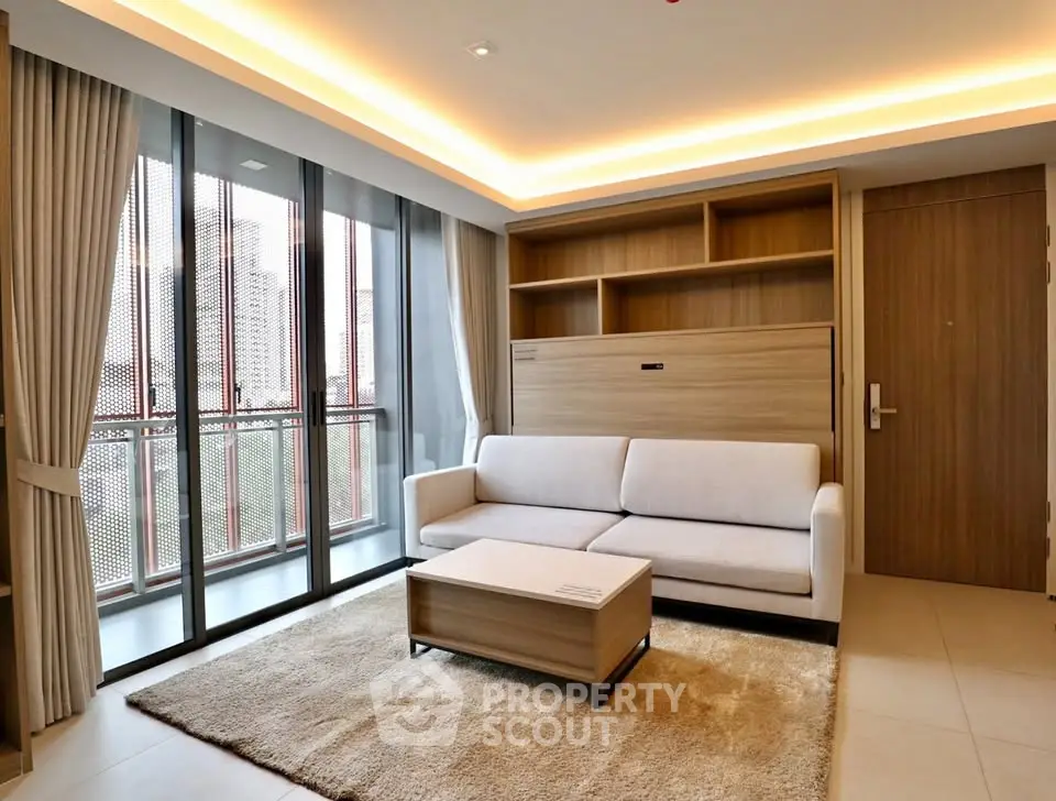 Modern living room with large windows and stylish furniture in a contemporary apartment.