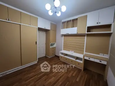 Spacious bedroom with built-in storage and modern lighting